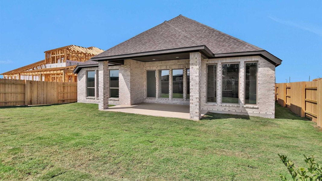 Front exterior of a new home in Elyson 55', Katy, TX, highlighting curb appeal (Image 1). Front exterior of a new home in Elyson 55', Katy, TX, highlighting curb appeal (Image 1).