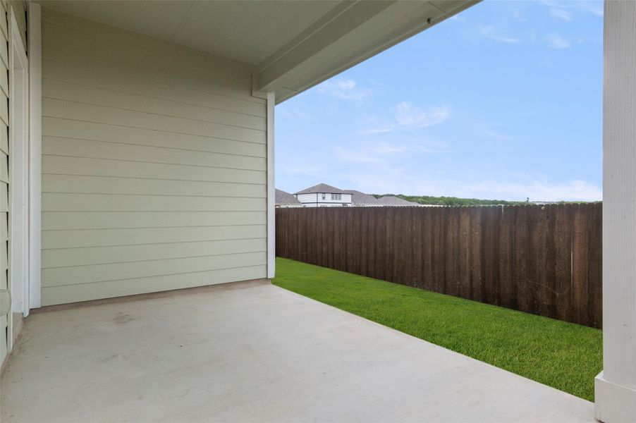 Fenced backyard with a patio