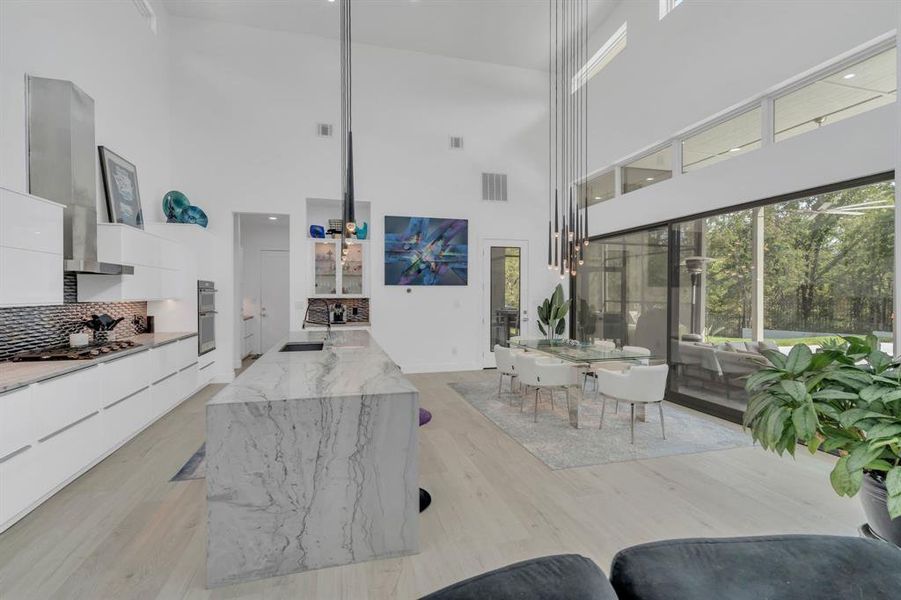 Living area featuring a high ceiling and light wood-style floors