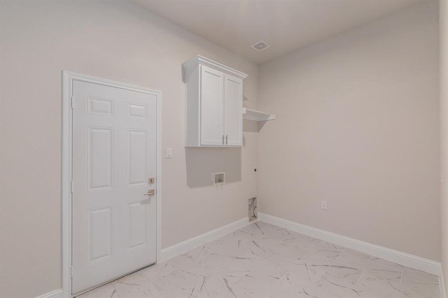 Washroom featuring cabinets, washer hookup, and electric dryer hookup