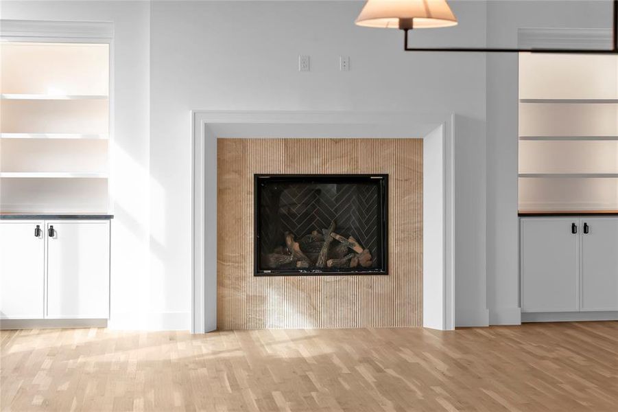 Detailed view of wood finished floors and a fireplace Detailed view of wood finished floors and a fireplace