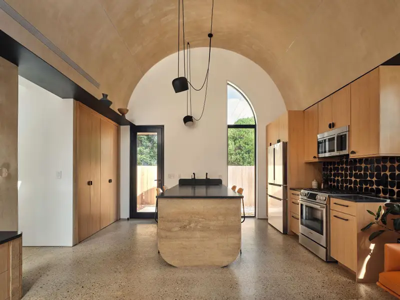 A warm and tactile blend of natural finishes: white oak cabinetry, terracotta, marble, and lime washed walls.