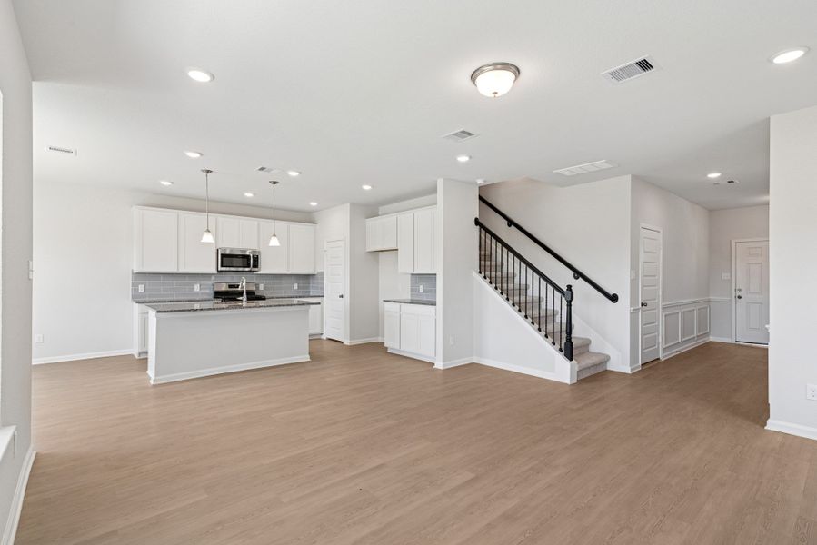 The Oriole II- Family Room into Kitchen. Sample image to be used for example only, colors, options and upgrades vary.