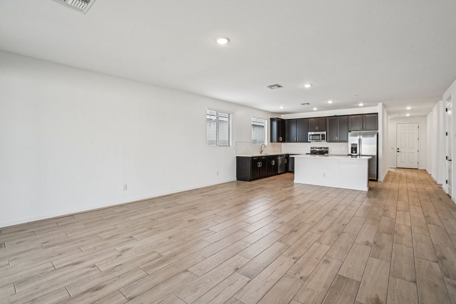 Great room, dining and kitchen. Finishes may vary by community.
