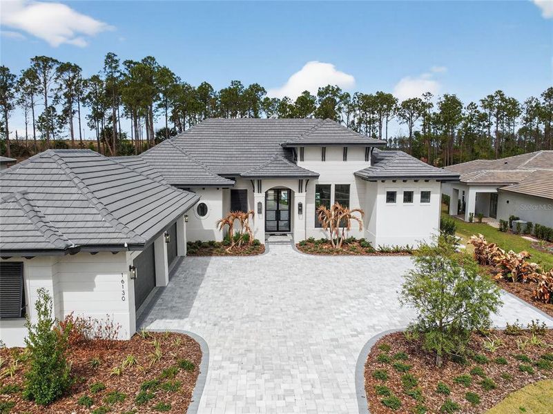 Front exterior of a new home in , Montverde, FL, highlighting curb appeal (Image 1). Front exterior of a new home in , Montverde, FL, highlighting curb appeal (Image 1).