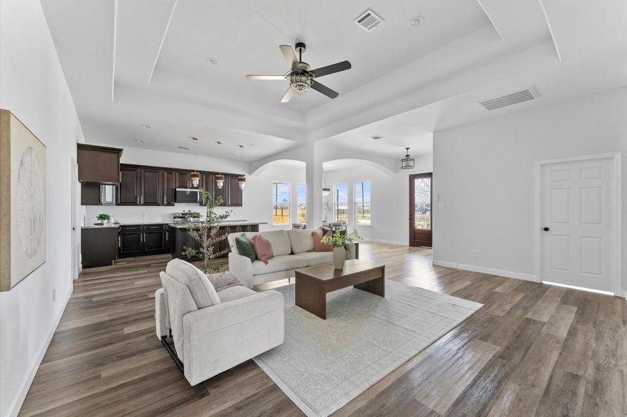 Spacious living room with soaring ceilings, abundant natural light, and seamless flow to the dining and kitchen. Spacious living room with soaring ceilings, abundant natural light, and seamless flow to the dining and kitchen.