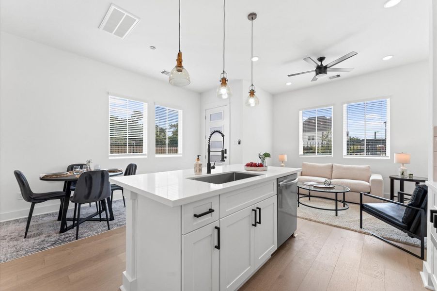 At the heart of this open-concept kitchen lies a stunning oversized island, offering generous prep space, sleek quartz countertops, and seating area. Whether you're hosting a dinner party or enjoying a casual breakfast, this island is the perfect gathering spot. Pendant lighting adds a touch of elegance, and the deep sink makes it as functional as it is beautiful.