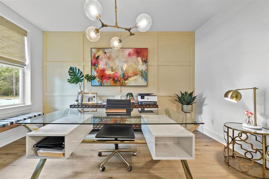 Light and bright front facing office with wood paneled accent wall.