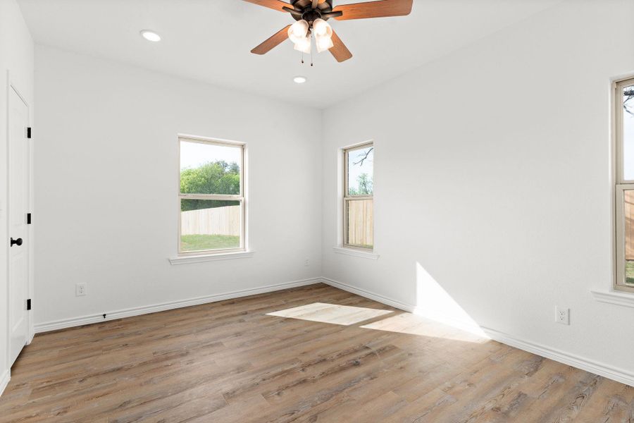 Spare room featuring light wood-style floors, baseboards, a ceiling fan, and recessed lighting Spare room featuring light wood-style floors, baseboards, a ceiling fan, and recessed lighting