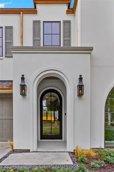 View of exterior entry featuring stucco siding