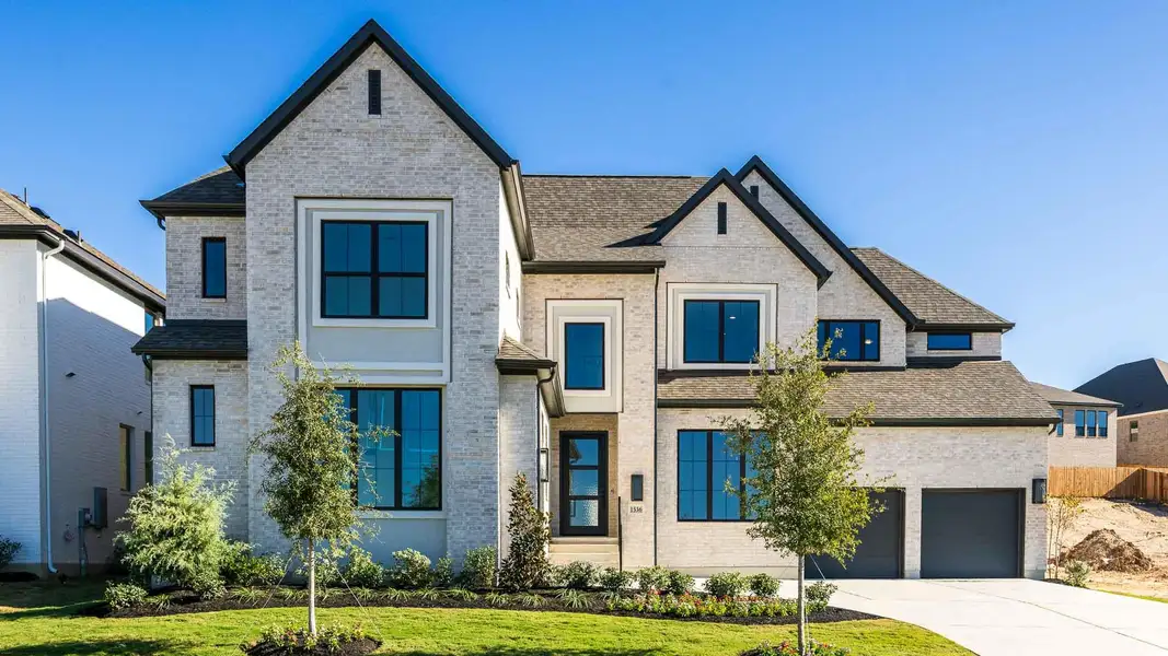 Front exterior of a new home in Palmera Ridge 70', Leander, TX, highlighting curb appeal (Image 2). Front exterior of a new home in Palmera Ridge 70', Leander, TX, highlighting curb appeal (Image 2).