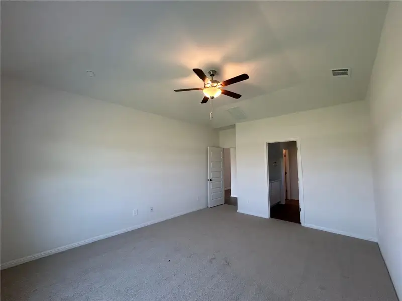 Unfurnished bedroom with carpet flooring and ceiling fan Unfurnished bedroom with carpet flooring and ceiling fan