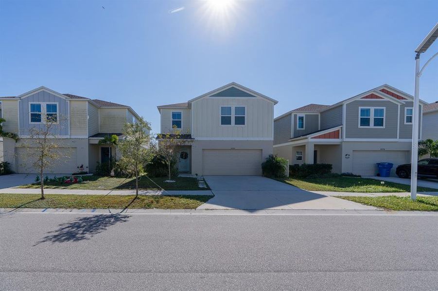 Front exterior of a new home in Pasadena Point, Wesley Chapel, FL, highlighting curb appeal (Image 28). Front exterior of a new home in Pasadena Point, Wesley Chapel, FL, highlighting curb appeal (Image 28).