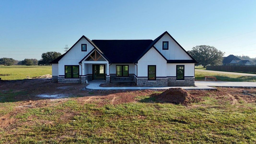 Front exterior of a new home in , Angleton, TX, highlighting curb appeal (Image 1).
