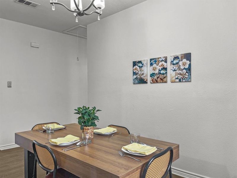 Dining area with dark wood-style flooring