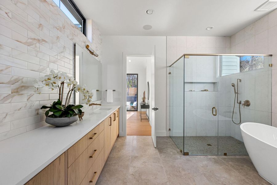Bathroom featuring a stall shower, vanity, a soaking tub, and recessed lighting