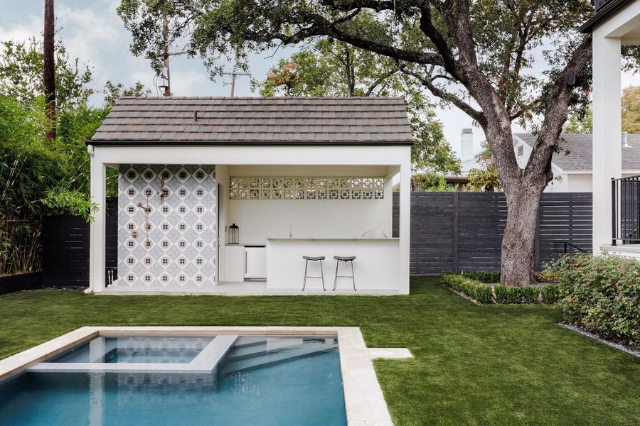 Integrated barbecue, bar seating, and stone surfaces make entertaining effortless and stylish. Integrated barbecue, bar seating, and stone surfaces make entertaining effortless and stylish.