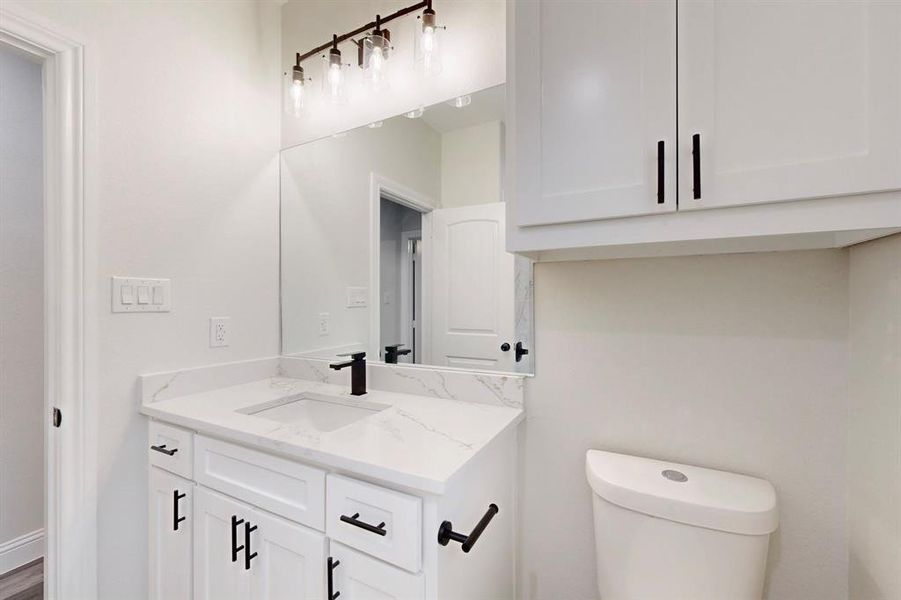 Bathroom featuring vanity and toilet