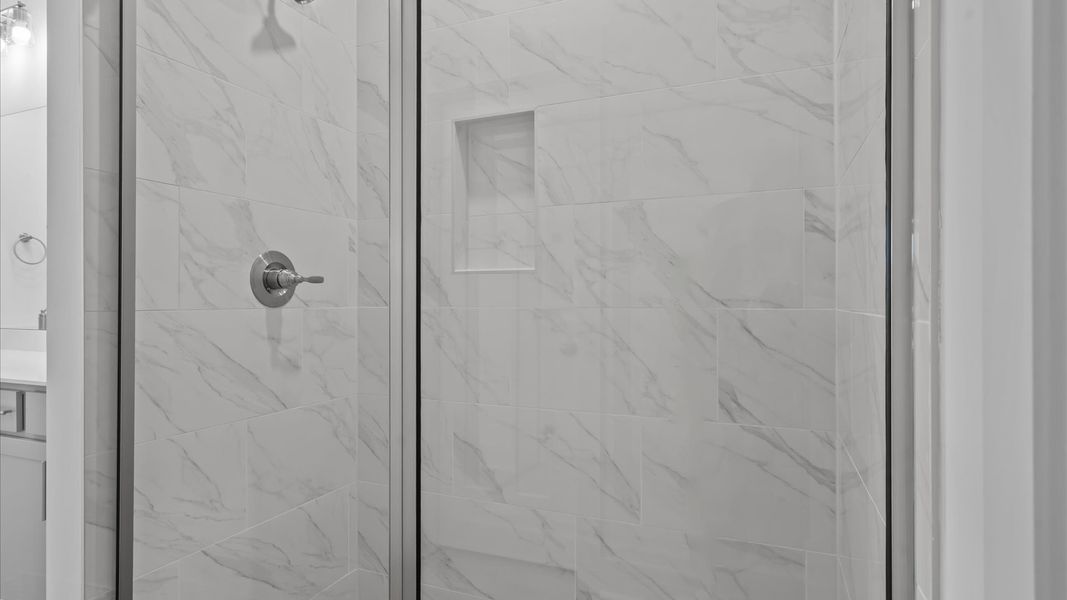 Superior en-suite primary bathroom with stylish dual vanity and tiled walk-in shower crafted with high standards in mind