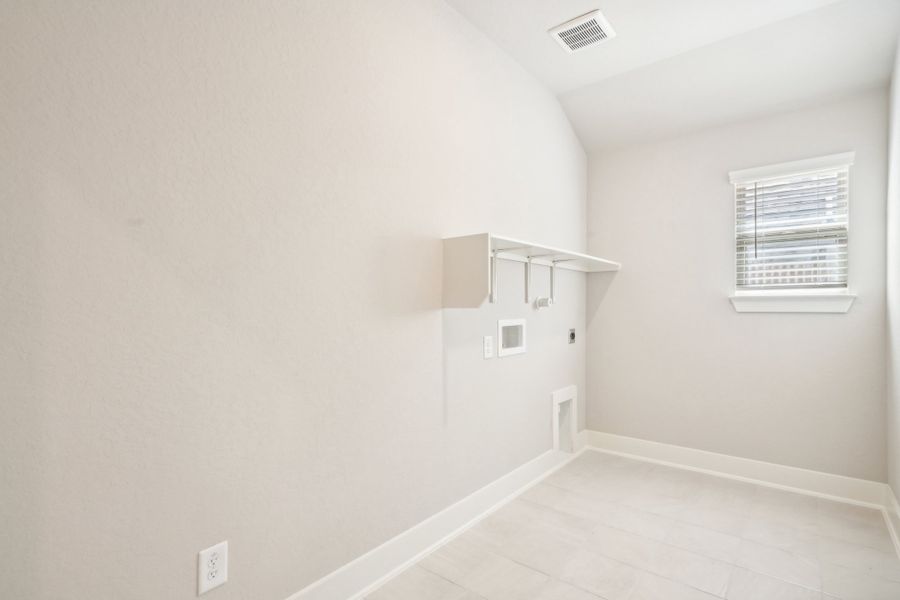 Laundry room in the Preston floorplan at a Meritage Homes community.