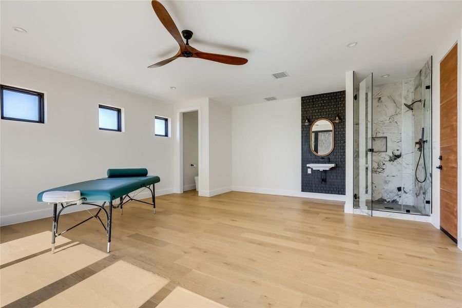 Sitting room featuring ceiling fan, light wood-style flooring, and recessed lighting