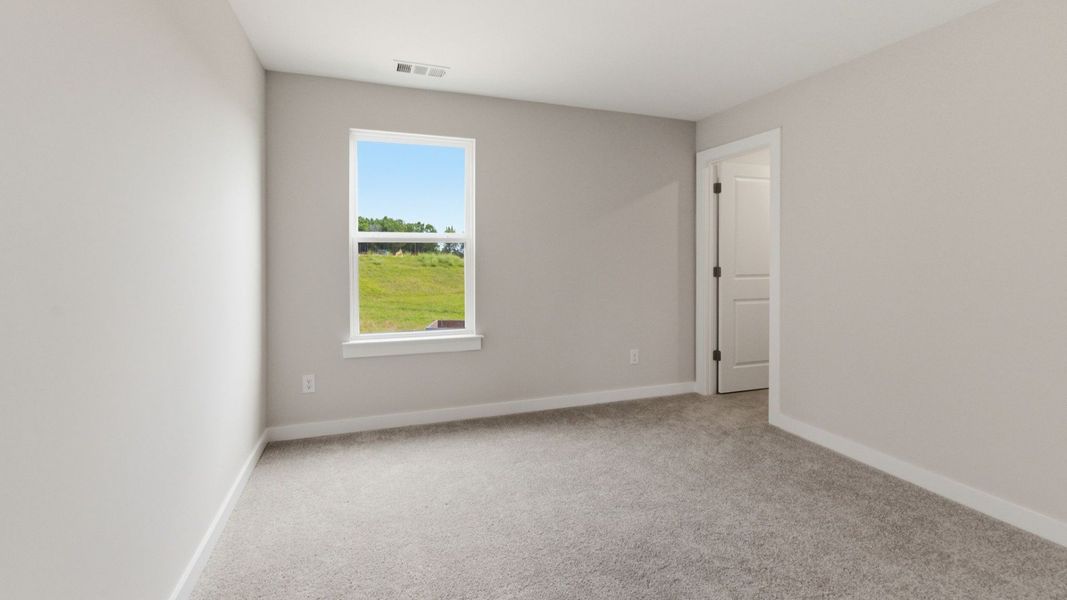 Bedroom with carpet and window