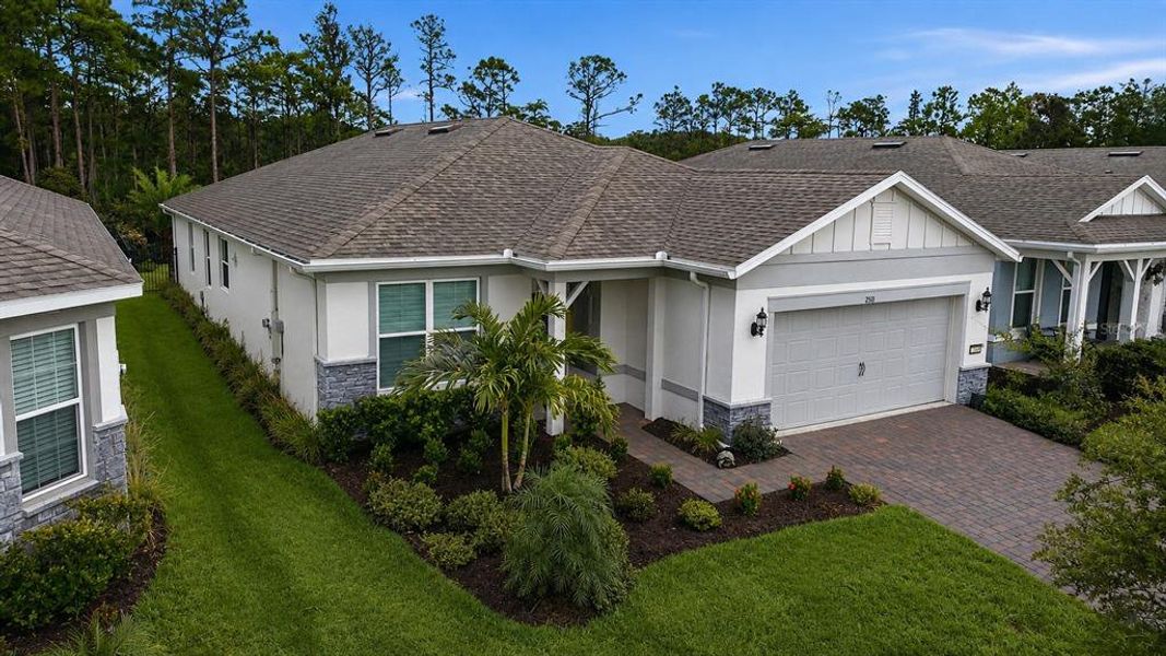 Front exterior of a new home in Del Webb Sunbridge, St. Cloud, FL, highlighting curb appeal (Image 2).