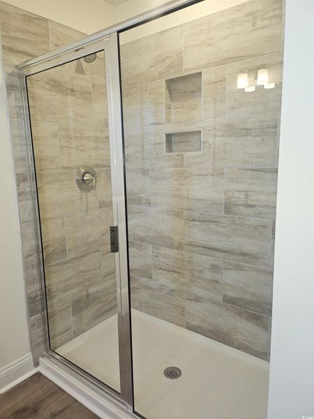 Bathroom with a stall shower and LVP flooring