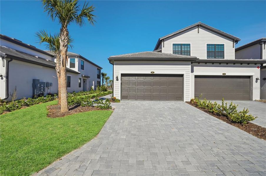 Front exterior of a new home in Legends Cove, Bradenton, FL, highlighting curb appeal (Image 19).