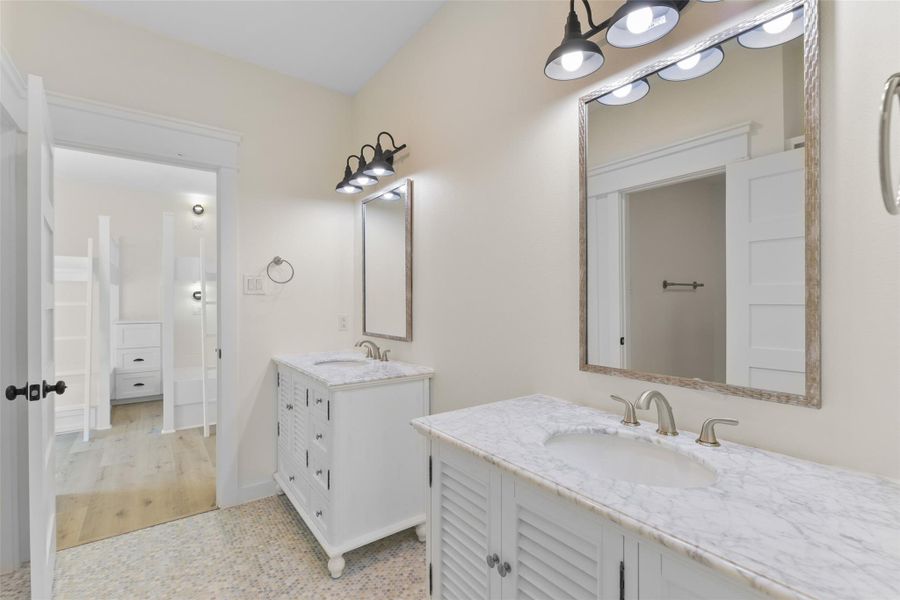 The adjoining bathroom features two separate vanities. The adjoining bathroom features two separate vanities.