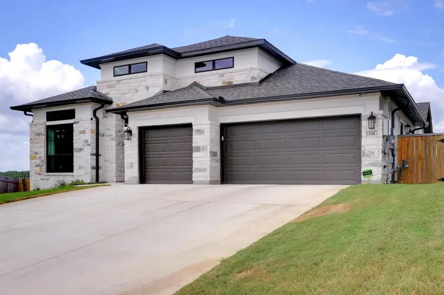 Front exterior of a new home in La Cima 60', San Marcos, TX, highlighting curb appeal (Image 2). Front exterior of a new home in La Cima 60', San Marcos, TX, highlighting curb appeal (Image 2).