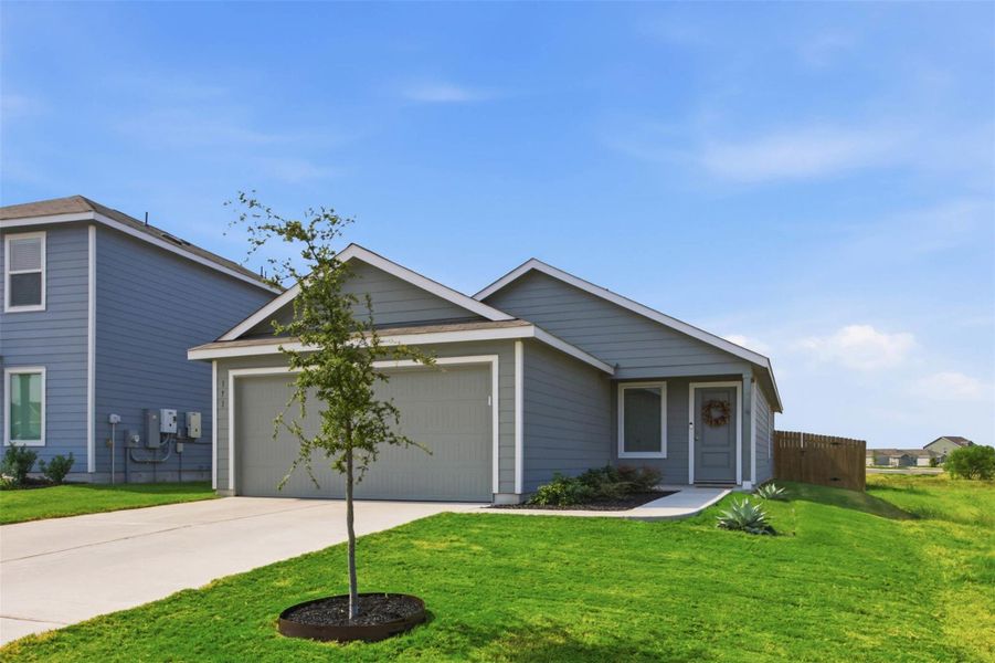 Modern hardie plank siding and a neat concrete driveway define this classic suburban exterior design.