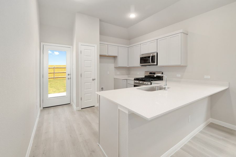 Kitchen in the Ash home plan by Trophy Signature Homes – REPRESENTATIVE PHOTO