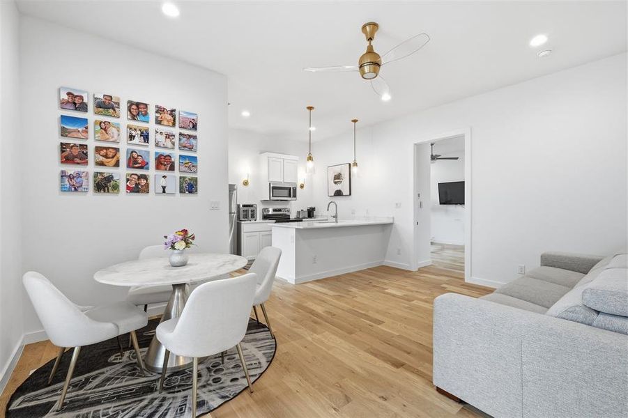 Dining room with light wood-style flooring, a ceiling fan, and recessed lighting