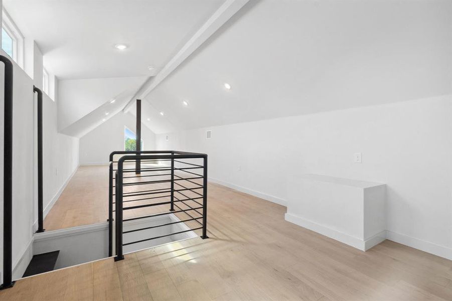 Bonus room with light wood finished floors and recessed lighting