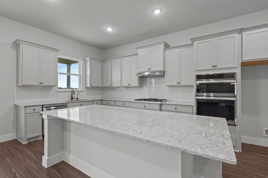 A kitchen with white cabinets. A kitchen with white cabinets.
