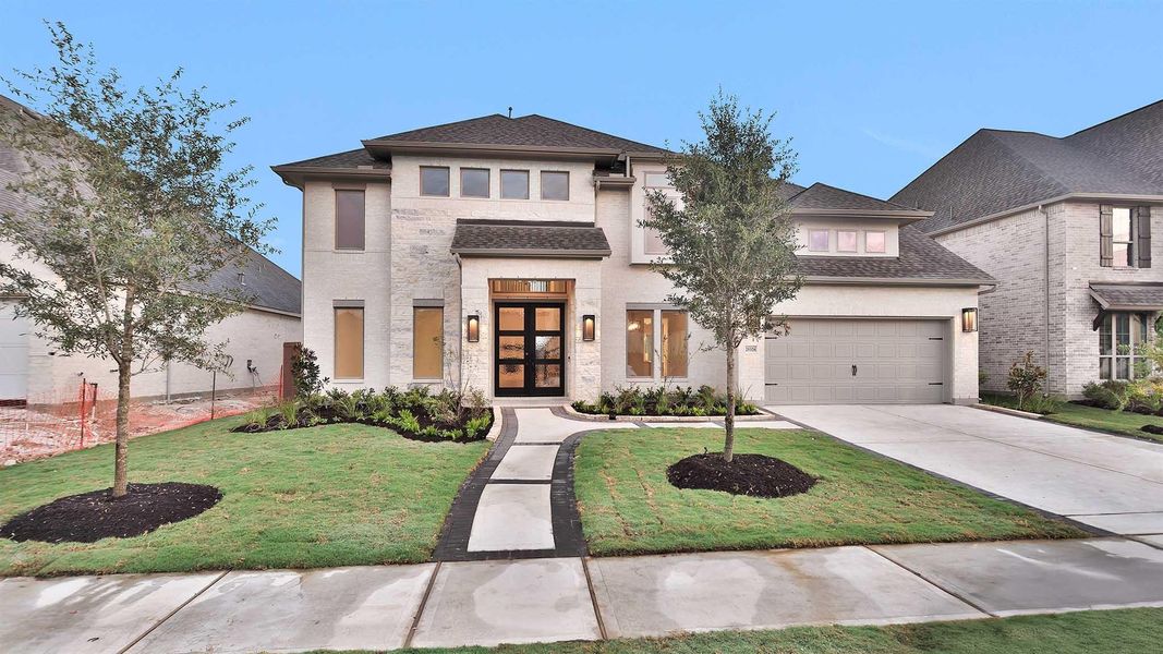 Front exterior of a new home in Elyson 65', Katy, TX, highlighting curb appeal (Image 1).