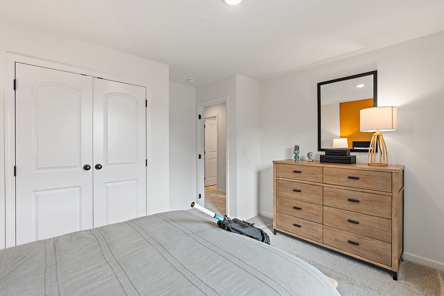 A bedroom with a bed and dresser. A bedroom with a bed and dresser.