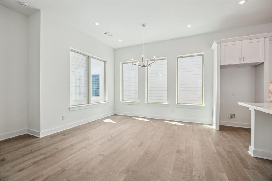 Dining Room that is Surrounded by Windows * Modern Fixtures * Designer Chandelier.