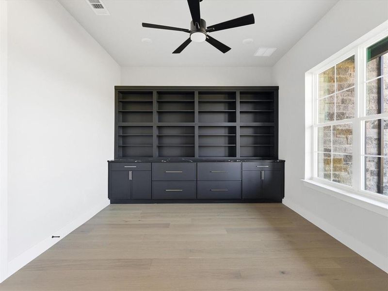 Unfurnished room featuring light wood-type flooring and ceiling fan