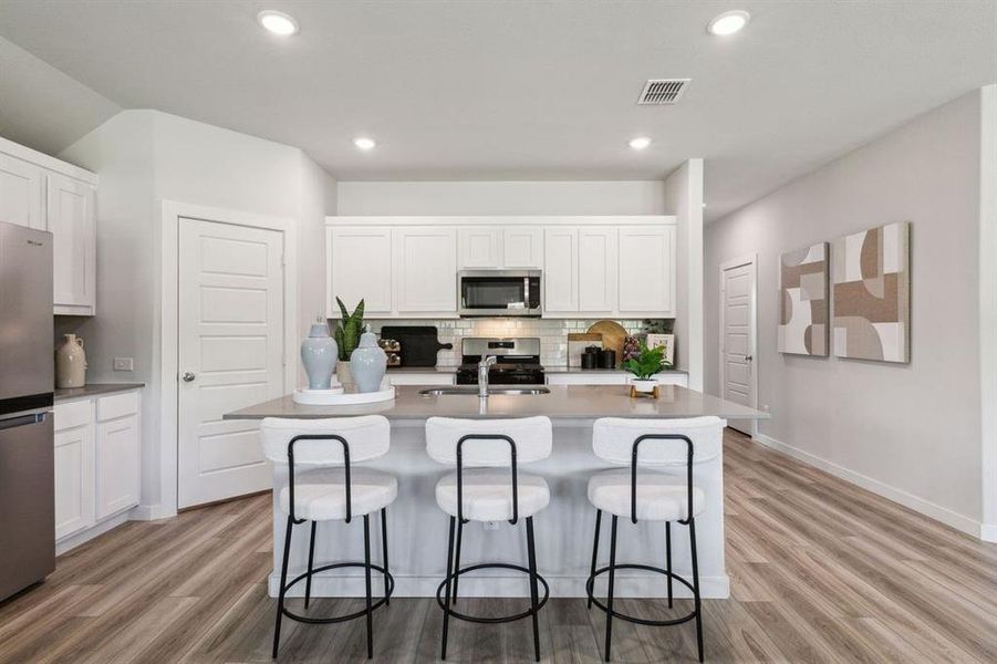 Kitchen in the Emmy II home plan by Trophy Signature Homes - REPRESENTATIVE PHOTO