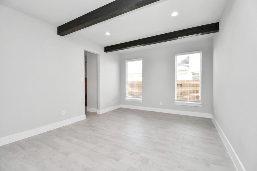 Craft enduring memories with loved ones around the table in this roomy dining area. Features wood beams, stylish flooring, personalized paint, and is conveniently situated next to the family room and kitchen, fostering an open and inclusive ambiance. Sample photo of completed home with similar floor plan. Actual colors and selections may vary.