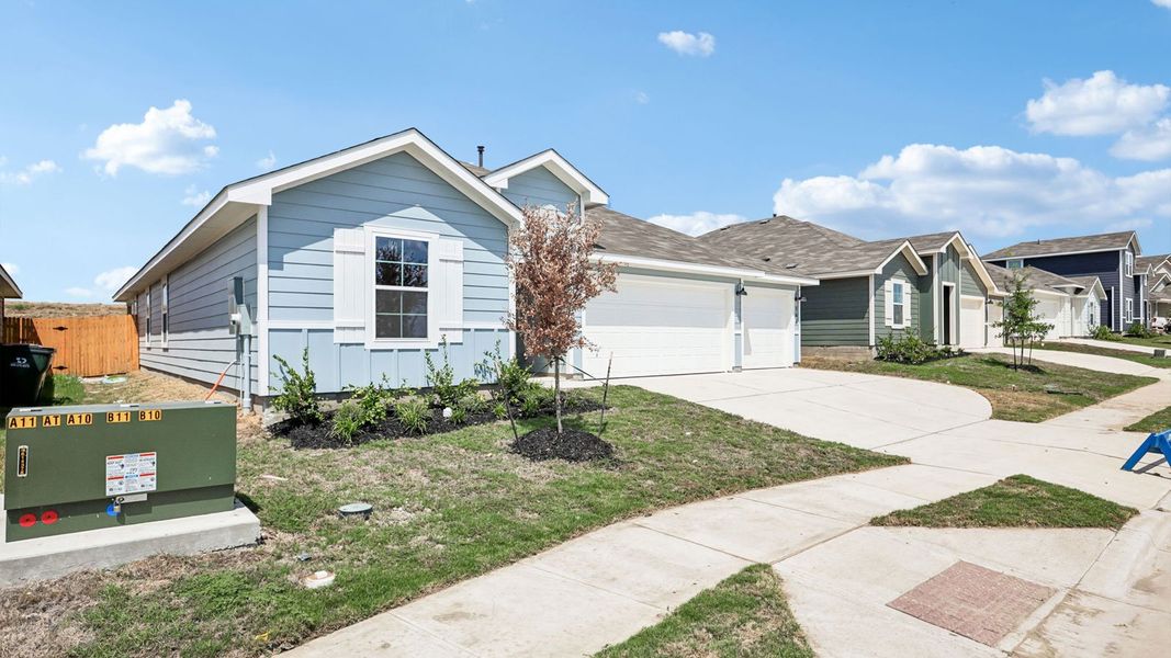 Front exterior of a new home in Prairie Lakes, Buda, TX, highlighting curb appeal (Image 21).