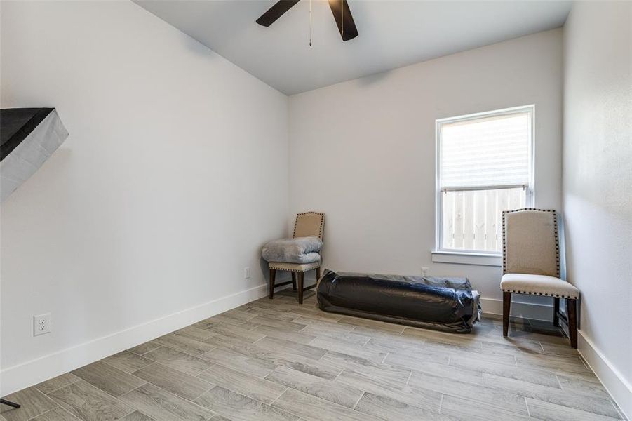 Sitting room with ceiling fan, wood finish floors, and baseboards