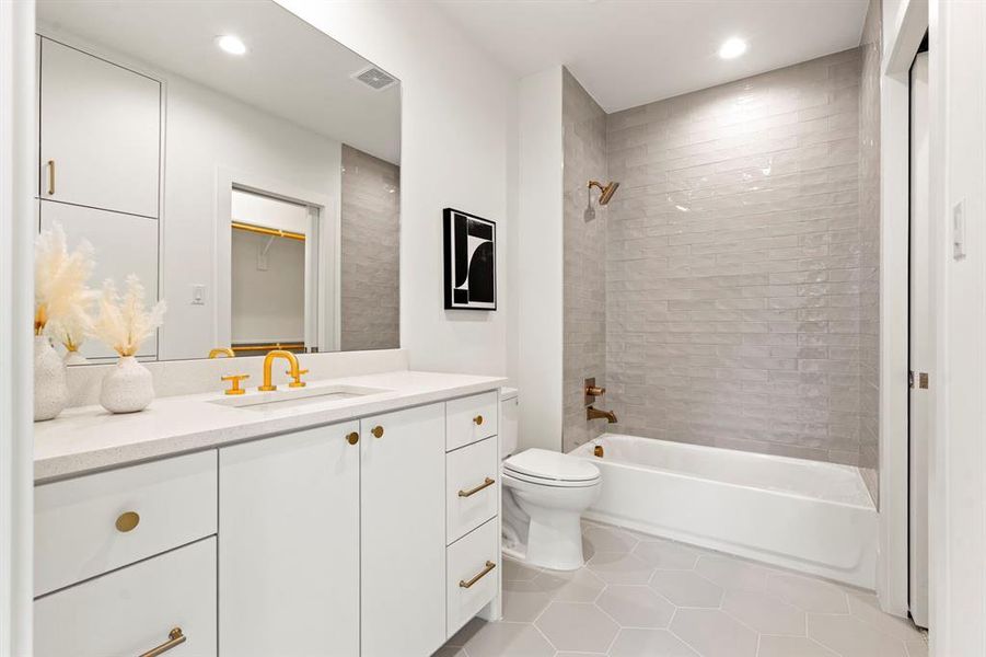 Bathroom with vanity, tile patterned flooring, shower / washtub combination, and recessed lighting Bathroom with vanity, tile patterned flooring, shower / washtub combination, and recessed lighting