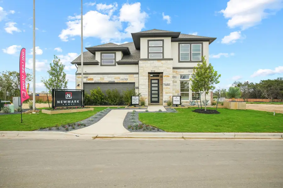 Front exterior of a new home in Anthem 50', Kyle, TX, highlighting curb appeal (Image 2). Front exterior of a new home in Anthem 50', Kyle, TX, highlighting curb appeal (Image 2).