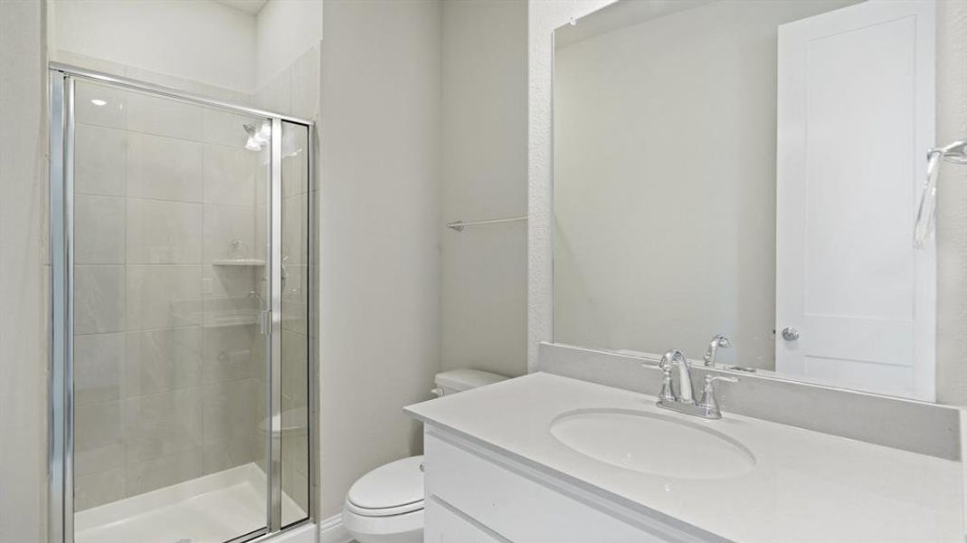 Bathroom featuring vanity and a shower stall Bathroom featuring vanity and a shower stall