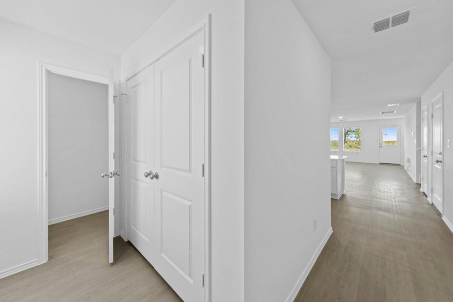 Hall featuring light wood finished floors