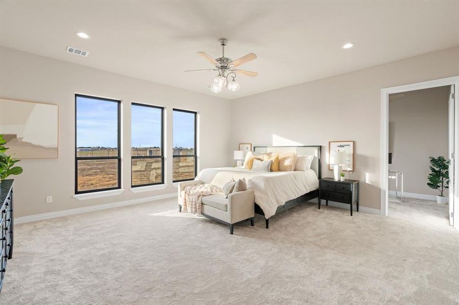 Bedroom with ceiling fan and light carpet