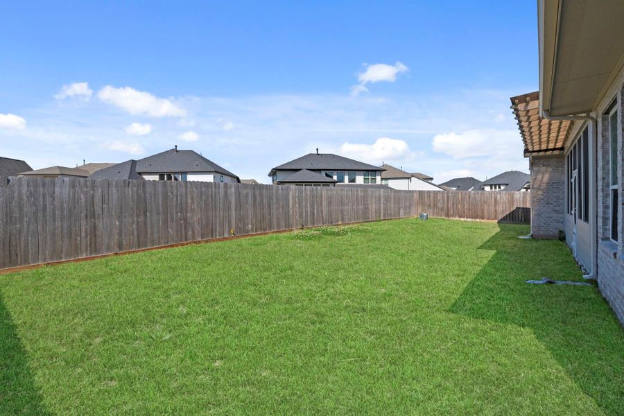 Generous backyard with open green space and privacy fencing—perfect for play, pets, or future outdoor enhancements.